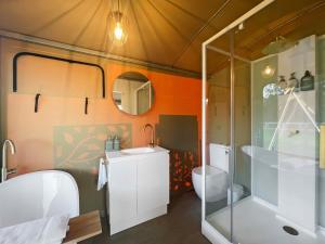 a bathroom with a shower and a toilet in a tent at Gumnut @ The Beltree in Belford