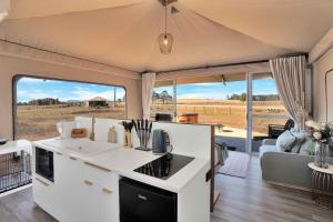 a caravan with a kitchen and living room with a view at Gumnut @ The Beltree in Belford