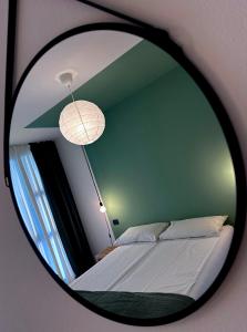 a mirror reflection of a bed in a bedroom at Il Nido del Pettirosso - by Osteria del Pettirosso in Rovereto
