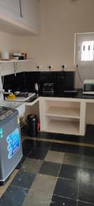 a kitchen with a black and white counter top at The Ghosh's Home stay in Hyderabad