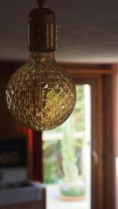 a glass light fixture hanging from a ceiling at Ländliches Wohnen zwischen Erfurt und Gotha in Erfurt