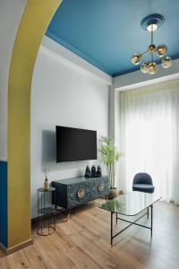 a living room with a couch and a tv at HOME OF THE SOUL in Ioannina