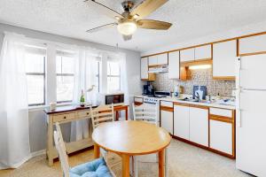 a kitchen with a table and a ceiling fan at The Inn at St Thomas Square 1203C in Panama City Beach