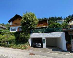 a car parked in a garage in front of a house at Haus Otis in Millstatt
