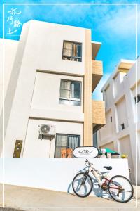 a bike parked in front of a building at On The Way Guesthouse in Magong