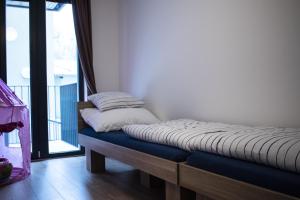 a pair of beds in a room with a balcony at Central Prague Vítkov - free parking in Prague