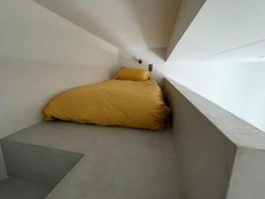 a bedroom with a yellow bed in a white room at House center of Athens, near Acropolis in Athens +6 photos