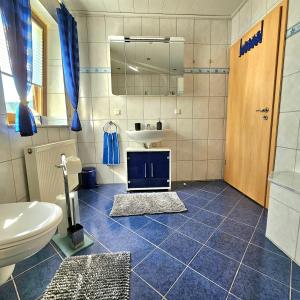a bathroom with a sink and a toilet in it at Ferienwohnung Jenny Edersee in Edersee