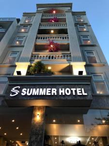 a building with a sign for a summer hotel at Summer Beach Hotel Vung Tau in Vung Tau