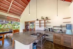 a kitchen with a large table in a room at Ohana Resort Siargao in General Luna