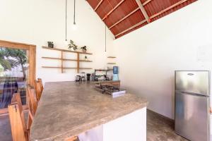 a kitchen with a counter and a refrigerator at Ohana Resort Siargao in General Luna
