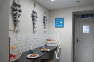 a kitchen with two plates of food on a counter at 3 Bedroom Cottage in Conwy with Parking Sleeps 4 in Conwy