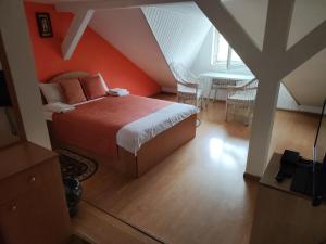 um quarto com uma cama com uma parede laranja em Inn Sport em Chernivtsi