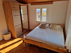 a bedroom with a bed and a window at Holiday home Barci in Crikvenica