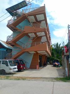 a building with a spiral staircase on the side of it at RNEK Boatel Commercial Space in Moalboal