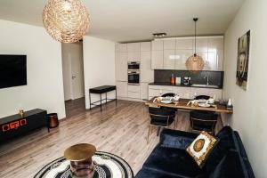 a living room with a couch and a table and a kitchen at AH Designe in Košice