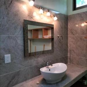 a bathroom with a sink and a mirror at Loft by Yuum Kiin Bacalar in Rancho Bacalar