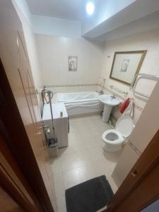 a bathroom with a tub and a toilet and a sink at Your comfort is our responsibility in Ulaanbaatar