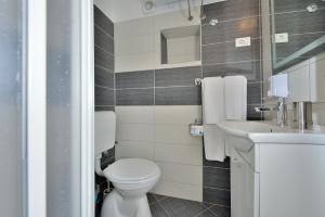 a bathroom with a toilet and a sink at Apartments Donat in Zadar