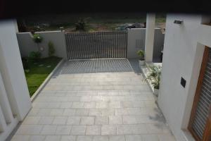 a walkway leading into a house with a fence at Earth - Luxurious 5 BHK AC Villa at Mysore in Mysore