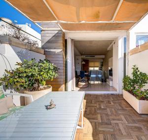 an outdoor patio with a table and plants at Luxury home with sea views in St. Julianʼs