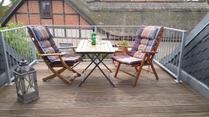 two chairs and a table on a deck at Wohnung Nr 4 in Bargischow