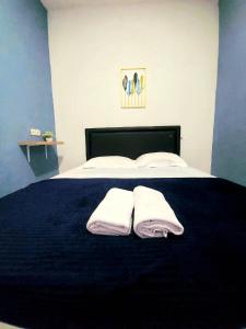 a bedroom with a bed with two towels on it at FHStay Malioboro in Timuran
