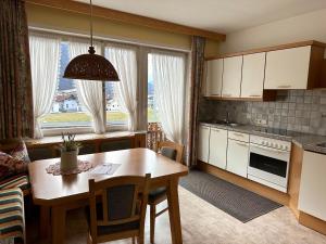 a kitchen with a table and a dining room at Haus Hermine in Tarrenz