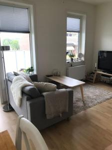 a living room with a couch and a coffee table at 1-bed for 2 pers Central in Lillestrøm in Lillestrøm