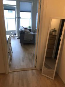 a living room with a mirror and a couch at 1-bed for 2 pers Central in Lillestrøm in Lillestrøm