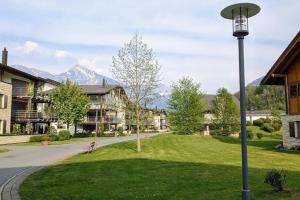 a street light in the middle of a park with mountains at Wonderful holiday home on the shore of Walensee in Quarten