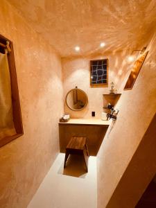 a bathroom with a sink and a mirror at Dongbok Sanjang Jeju in Jeju +28 photos