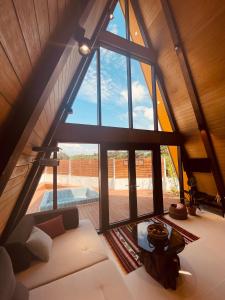 a living room with a large window and a white couch at Dongbok Sanjang Jeju in Jeju