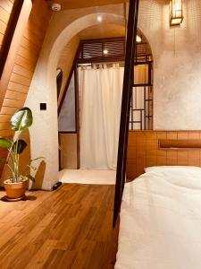 a bedroom with a bed and a large window at Dongbok Sanjang Jeju in Jeju
