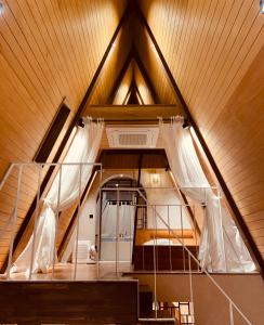 an attic room with a bed and a wooden ceiling at Dongbok Sanjang Jeju in Jeju