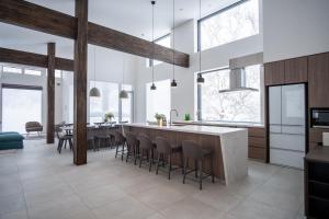 a kitchen with a large island with bar stools at Song Saa Chalet in Niseko