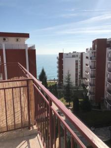 a balcony with a view of the ocean and buildings at Квартира у моря in Sveti Vlas