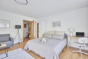 a white bedroom with a bed with a teddy bear on it at Imma - im idyllischen Walldürn-Glashofen in Walldürn