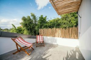 un patio con una silla y una valla en Batu Belig Living Apartment Seminyak, en Seminyak