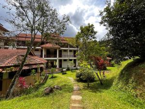 a house with a garden in front of it at ēRYA by SURIA Janda Baik in Bentong