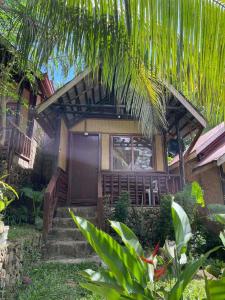 a house with stairs leading to the front of it at Novie's Tourist Inn in El Nido