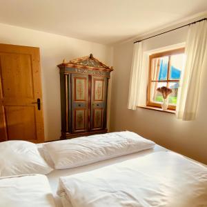 a bedroom with a bed and a cabinet and a window at Le Crode in Sesto