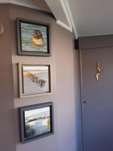 a hallway with three pictures on the wall at Gîte Le Sambre in Thuin