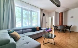 a living room with a blue couch and a table at NOOK NOOK Apartments Kazimierza Wielkiego 104 in Kraków