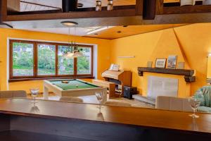 a living room with a pool table and a fireplace at Lizard House in Cevio