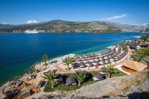 an aerial view of a beach with umbrellas and the ocean at Apartman Mariva in Dubrovnik