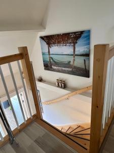 a stairway with a picture of the ocean on the wall at Thuis op Texel in Den Burg