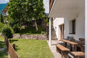 a backyard with a picnic table and a bench at Falgerhof in Vollan +45 photos