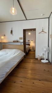 a bedroom with a bed and a table and a mirror at NORD 3 自然豊かな家 - Manji Village - in Iwamizawa