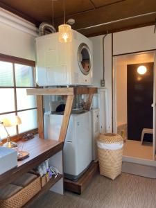 a kitchen with a washer and dryer in a tiny house at NORD 3 自然豊かな家 - Manji Village - in Iwamizawa